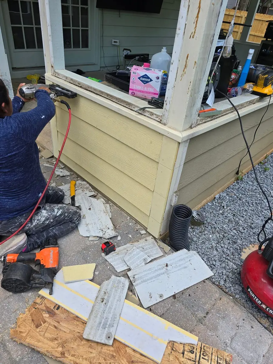 Siding repair underway at a porch opening
